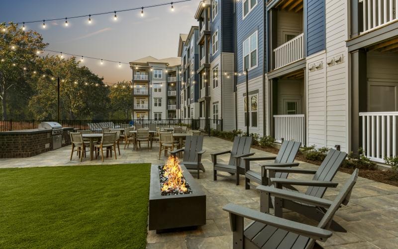 an outdoor seating area with chairs and a fire pit