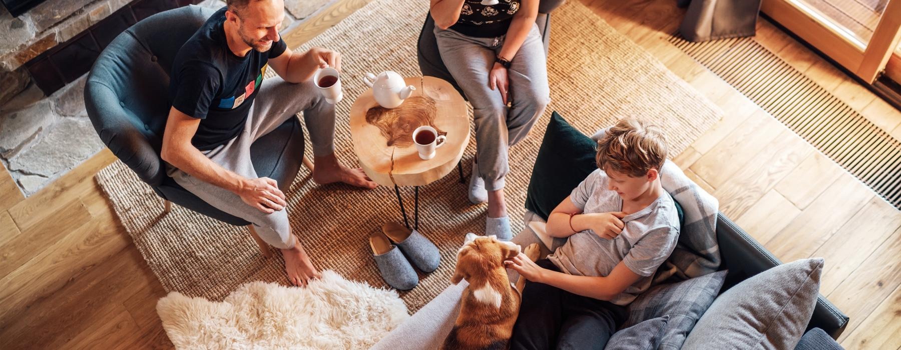 a group of people sitting around a table with a dog